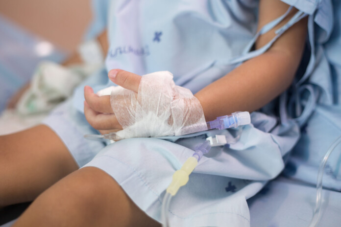 Hand of a patient in hospital ward